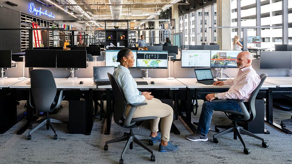 Men sitting at a table with computers.