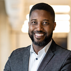 A man with a beard smiling.