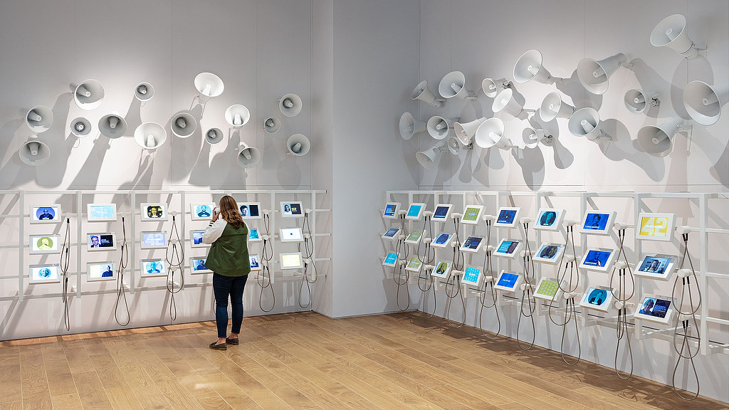 A person standing in front of a display of computers.