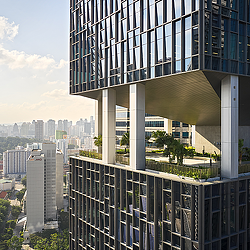 A building with a view of a city and trees.
